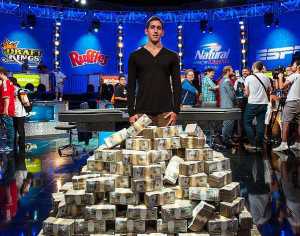 Daniel Colman stands on his pile of cash with not even a smile on his face.